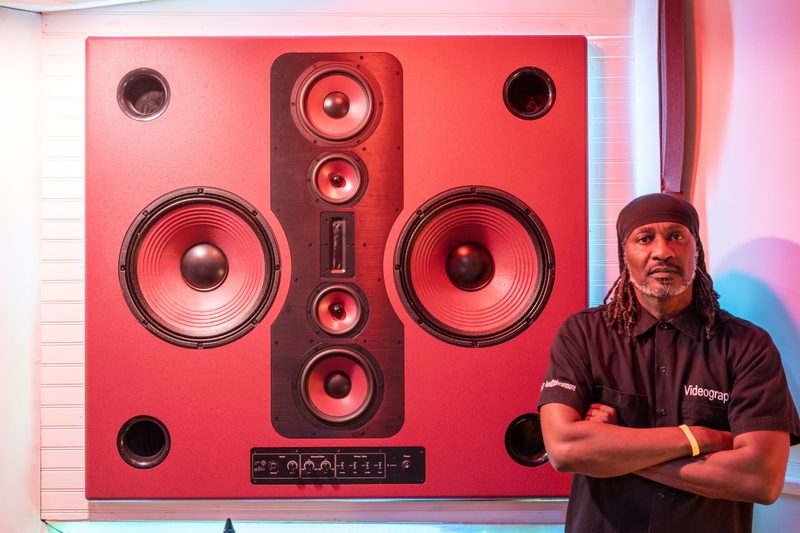 Rafael Capone in front of an SAS Acoustics speaker wall
