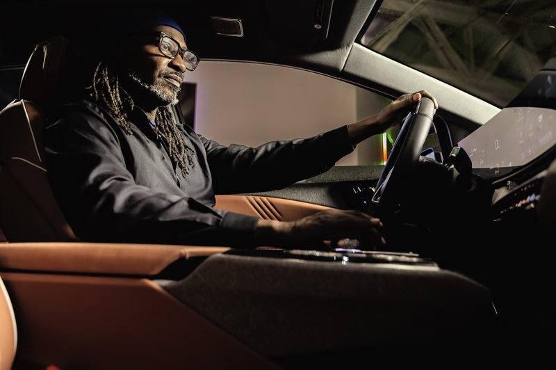 Rafael Capone at the wheel of a car, low-key light