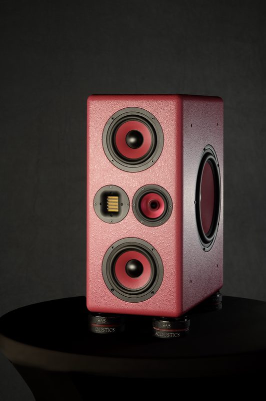 Pink SAS Acoustics studio monitor on a dark backdrop