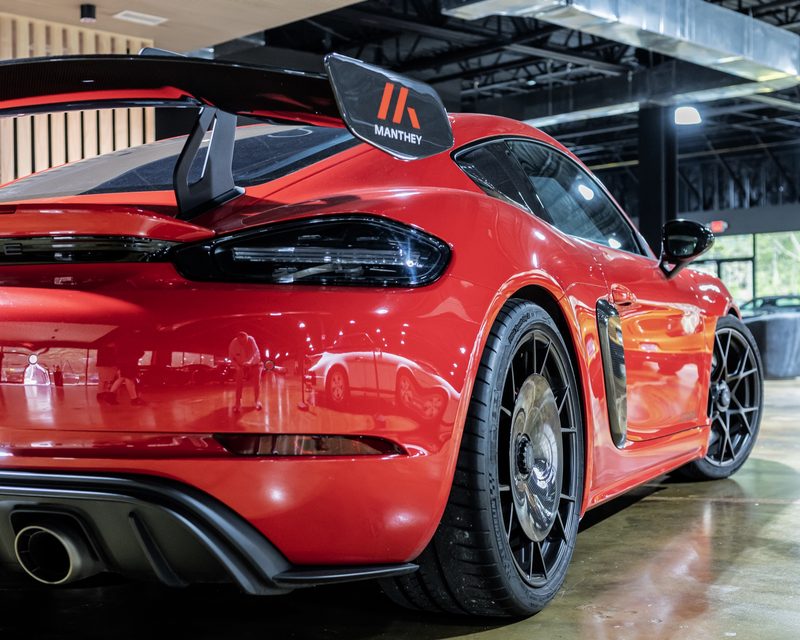 Red Porsche with a Manthey rear wing at The Ride Lounge